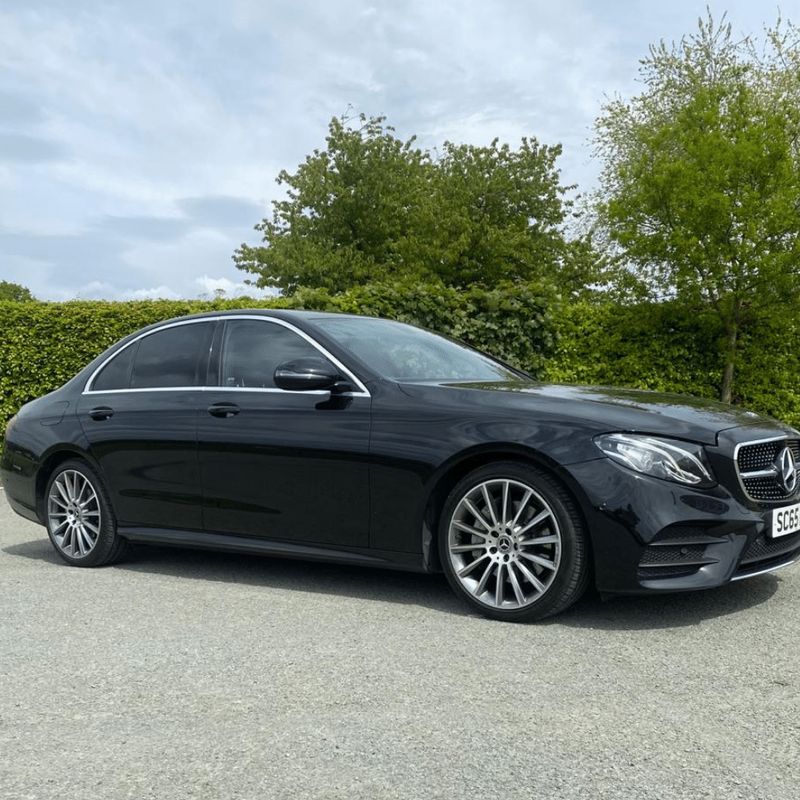A black Mercedes E-Class AMG Line saloon