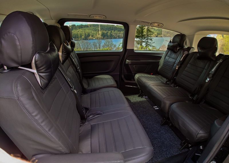 Two rows of black leather seats inside the Vito
